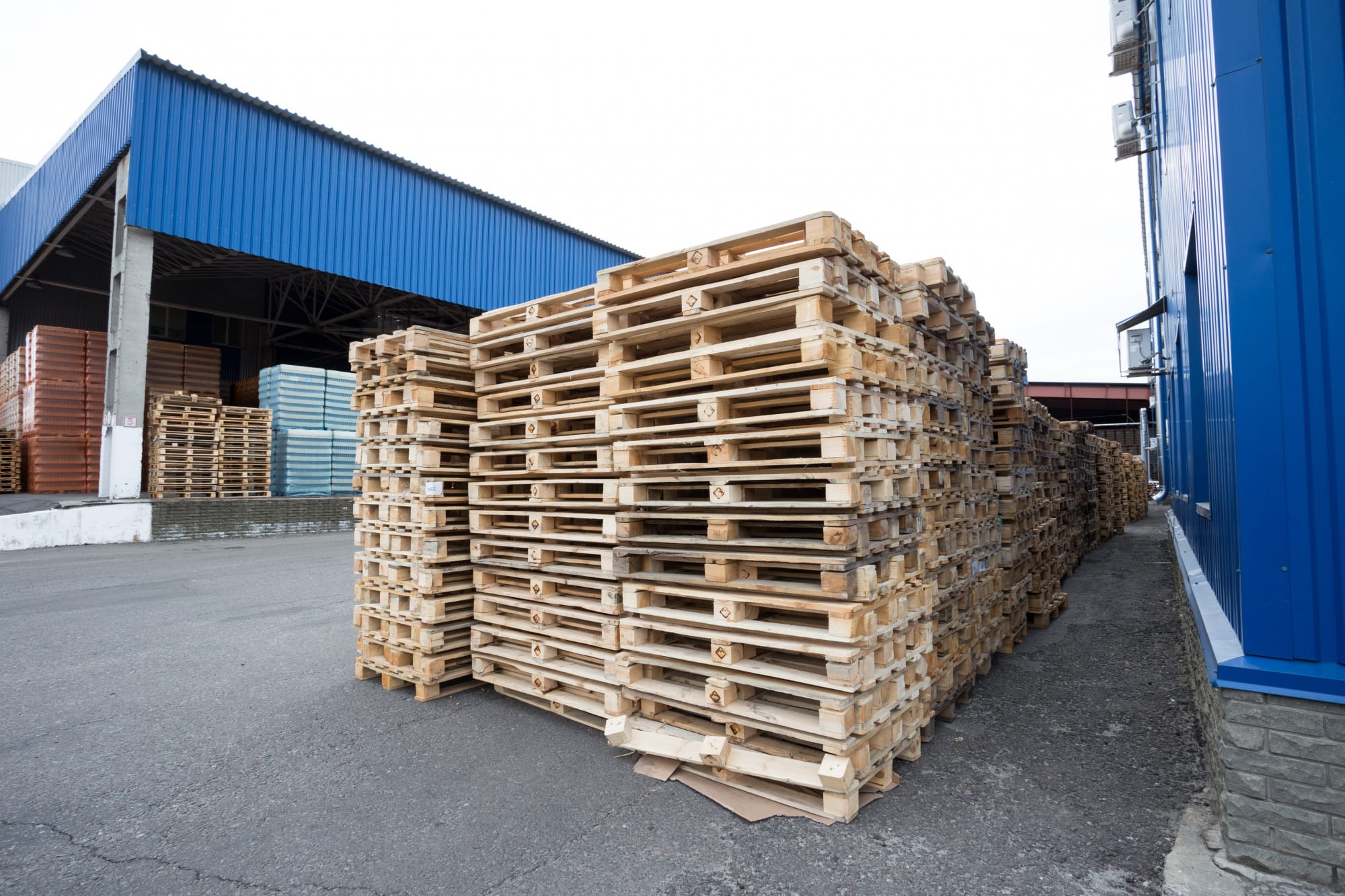 Stacked cheap wooden pallets ready to deliver from Palletwest