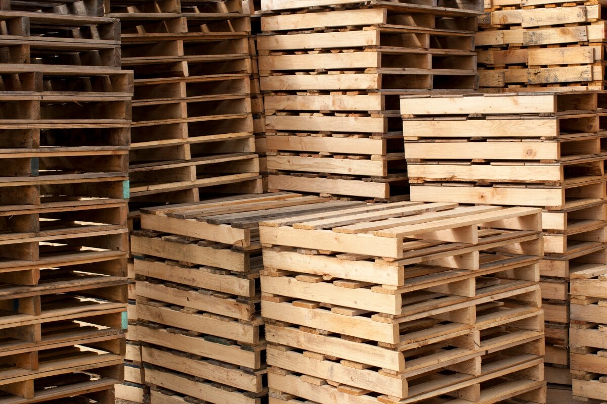 Stacks of wooden pallets arranged in a warehouse storage area
